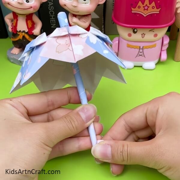 Make A 'J' Shape From The Bottom Of The Stick step by step Tutorial For Kids- Kids Can Create An Origami Umbrella With This Creative Tutorial 
