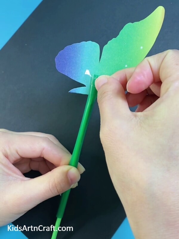 For The Final Step, Take A Cello Tape And Paste It, Just To Ensure Its Grip- An easy-to-follow tutorial for crafting a paper-straw butterfly for youngsters