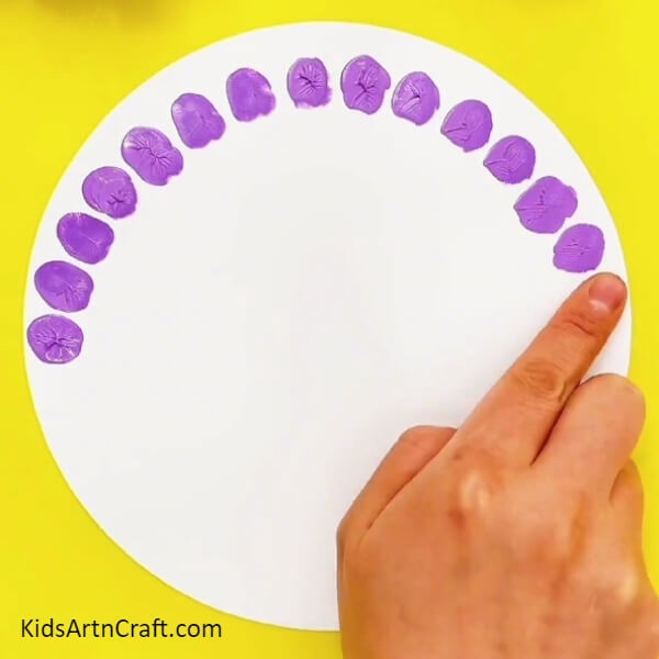 Make a semi-circular pattern with the finger impressions- Lovely Little Peacock Fingerprint Art For Kids