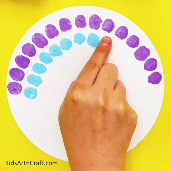 Dip your index finger in light blue paint and make impressions- Cute Peacock Finger Painting For Kids