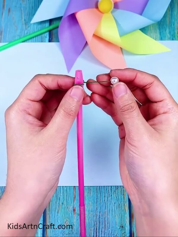 Inserting Wire in White Beat- How to Assemble a Rainbow Paper Windmill for Novices 