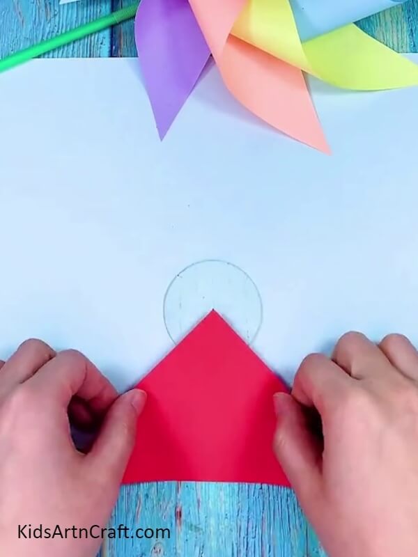 Pasting Red Color Paper with Tape- Step-by-Step Guide to Creating a Rainbow Paper Windmill 