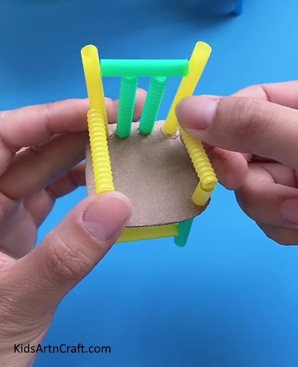 Attach The Smaller Pieces And Longer Pieces-Here's an instructional guide to constructing a chair from recycled cardboard and plastic straws.