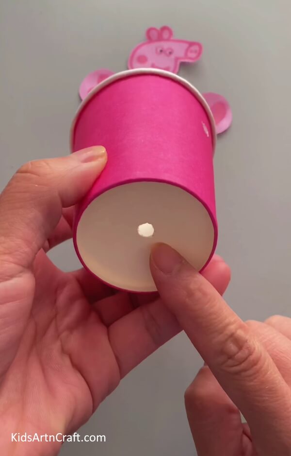 Making a Hole at the Bottom of the Cup- This guide will show children how to turn a recycled paper cup into a Peppa Pig hanging craft. 