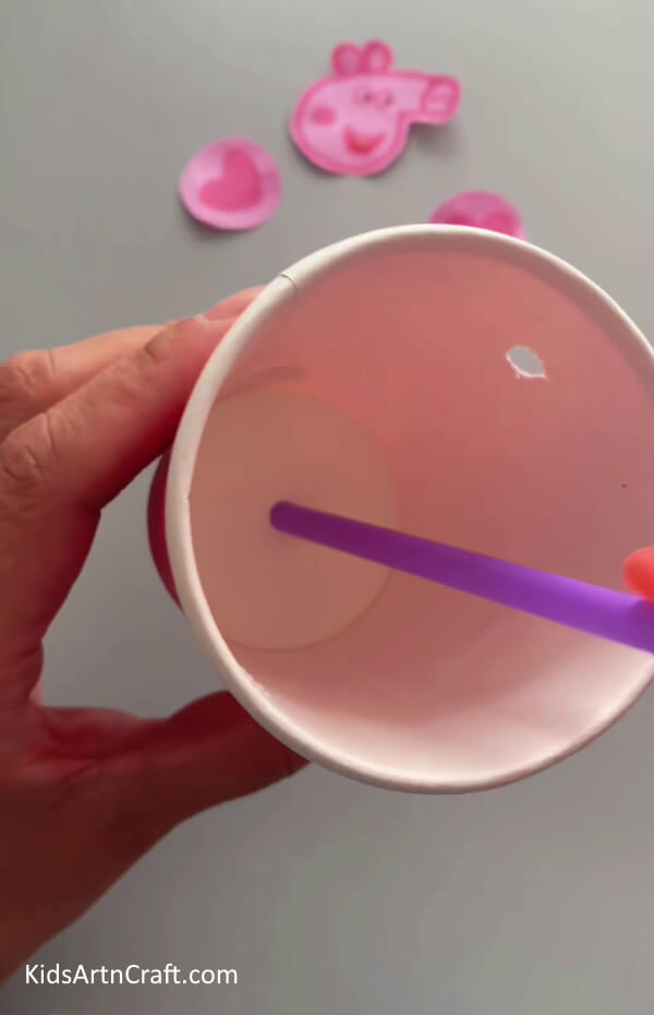Inserting the Purple Straw- This tutorial will show kids how to make a Peppa Pig ornament from recycled paper cups. 