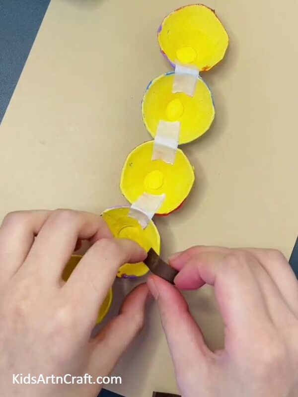 Sticking The Legs- Making a Caterpillar Out of an Egg Tray Easily for Children 