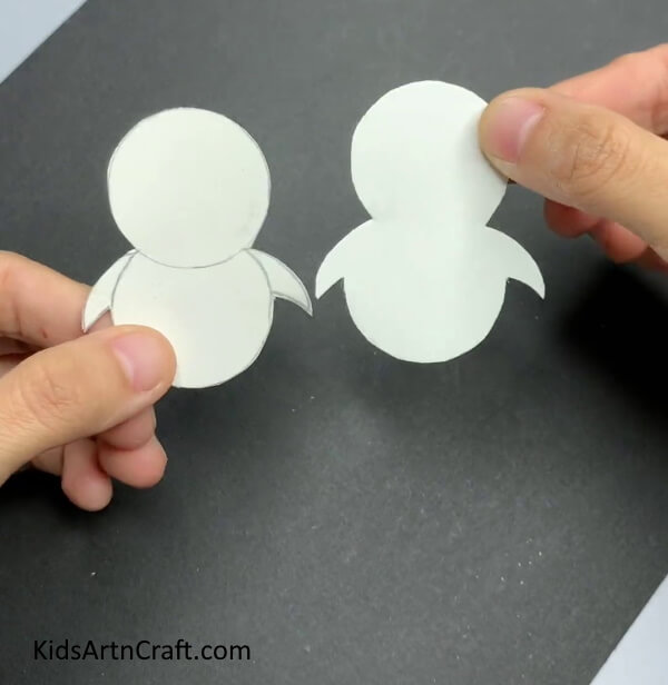 Cutting The Outline, You Must Now Have Two Identical Penguins- Creating a Paper Penguin Toy That Rocks with Bottle Cap and Clay