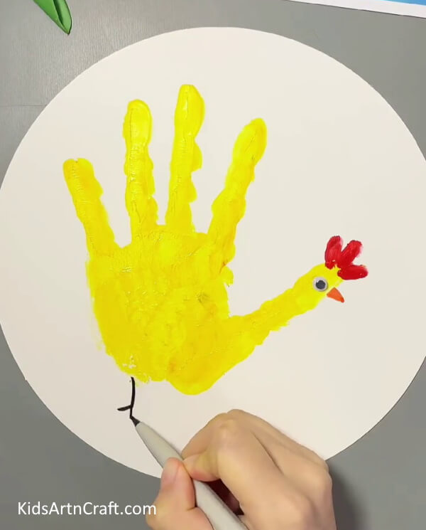 Legs of the Hen-This tutorial provides a simple, step-by-step guide to creating a handprint chicken with children. 