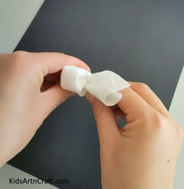 Bring The Folded Tissue Inwards on Crafting a Bunny with Tissue Paper for Kids- Instructions for children to create a bunny out of tissue paper 