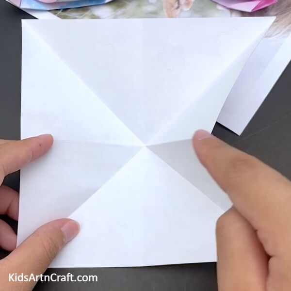 Making Fold Marks On The Sheet Of Paper Origami Boat Step-by-step Tutorial For Kids- Detailed guide on how to make a Paper Origami Boat for youngsters 