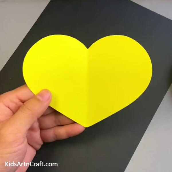 Creating A Heart Cut Out - Children can make a colorful butterfly craft using a throw-away spoon.