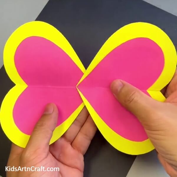 Pasting The Wings Together - A disposable spoon can be used to make a cheerful butterfly craft for kids.