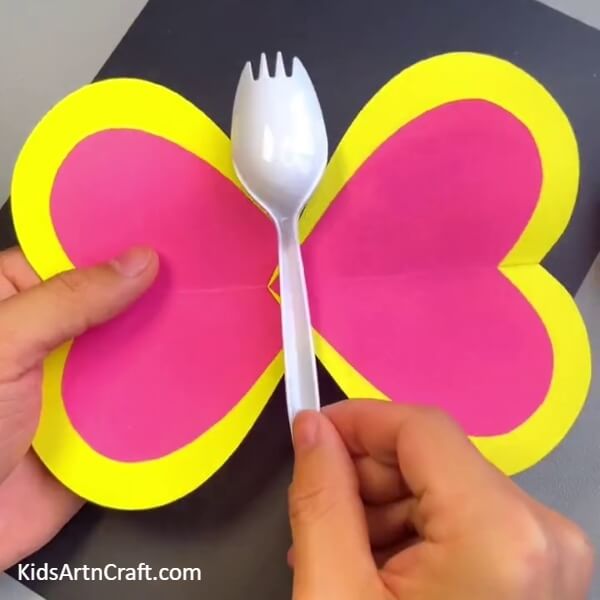 Pasting A Disposable Plastic Spoon - Crafty kids can make a lively butterfly using a disposable spoon.