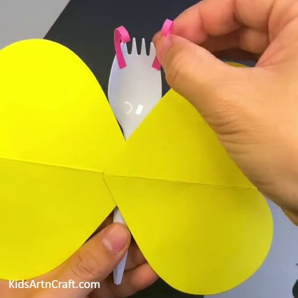 Adding Antennas - A throw-away spoon can be used to create a beautiful butterfly craft for children.