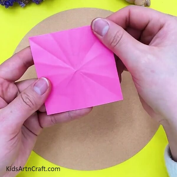 Cutting a square from pink color paper- Step-by-step 3D Flower Creation Guide for Children 