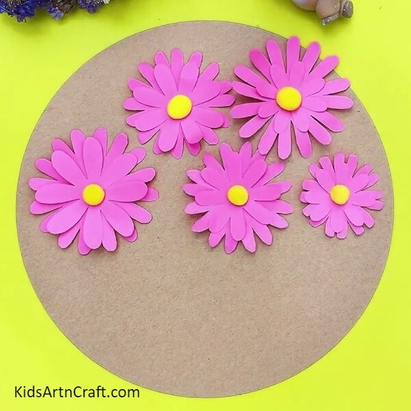 Creating three more flowers and pasting it on cardboard- Learn How to Make 3D Flowers with this Kid-Friendly Tutorial 