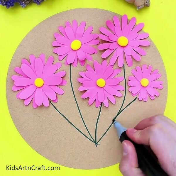 Drawing stems using green sketch pen- A Child-Friendly Guide on How to Make 3D Flowers 