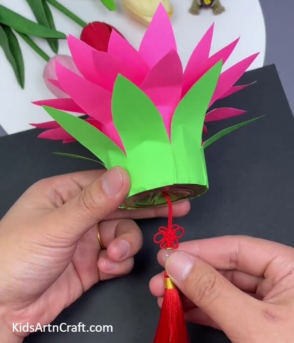Attaching thread in the hole 0f the container- Stunning Lotus Hanging Paper Crafting Decoration For Diwali