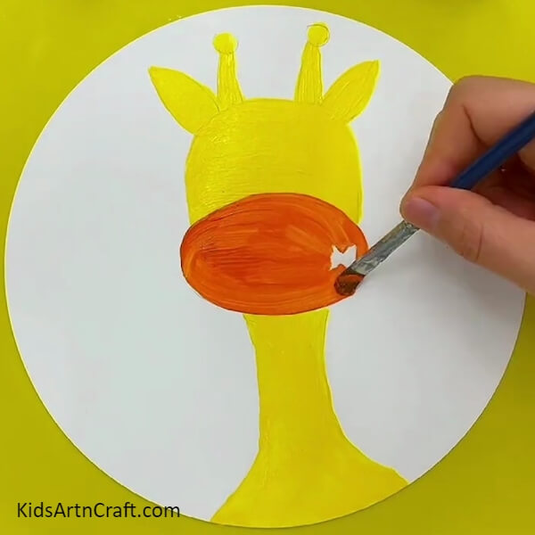 Painting The Giraffe's Mouth With Orange Color Paint-A beginner-friendly approach to decorating one's face with a Giraffe motif.