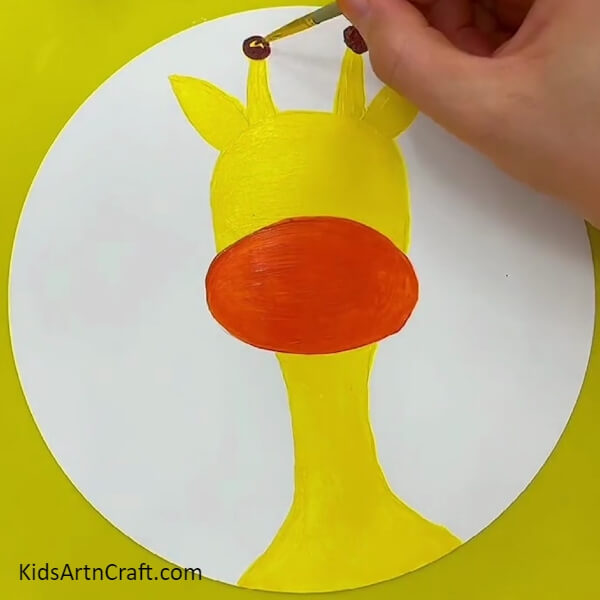 Painting Giraffe's Horn With Brown Color Paint- An easy Giraffe face painting thought for those just starting out
