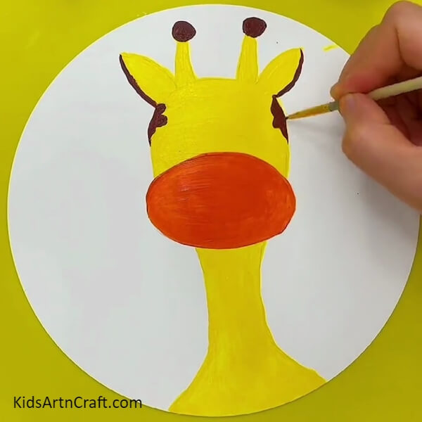 Painting Giraffe Pattern On The Giraffe Face Using Brown Color Paint- A great Giraffe-themed face-painting plan for the inexperienced