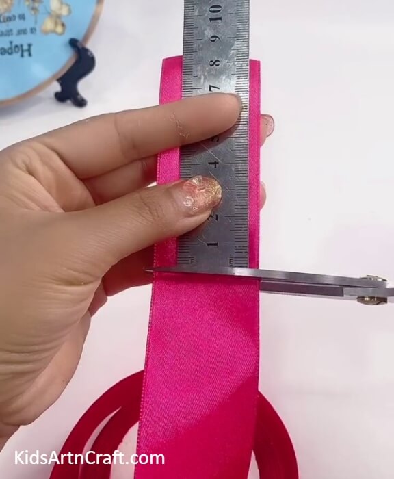 Cutting Out A Piece Of Ribbon-Tutorial for Kids on how to create a fake flower craft 