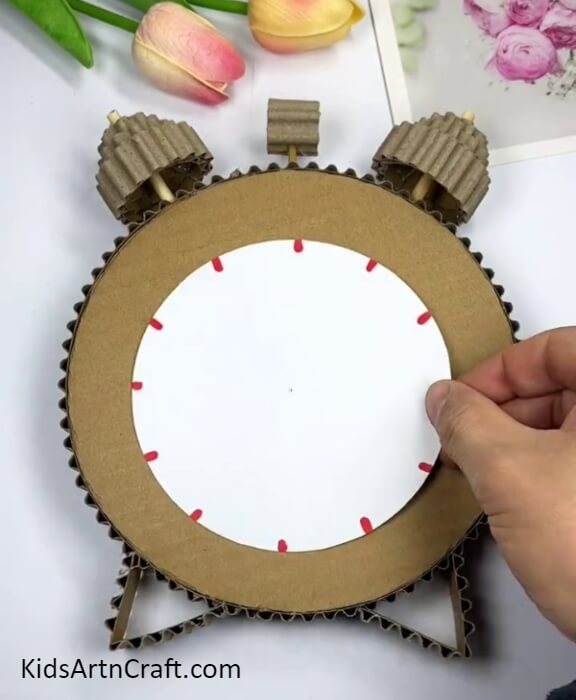 Making The Stand And Pasting A White Paper Circle- Crafting an Alarm Clock with Repurposed Cardboard -A Fun Activity for Kids 