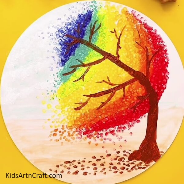 Painting some fallen leaves- A Rainbow Tree painting - a creative concept for the novice