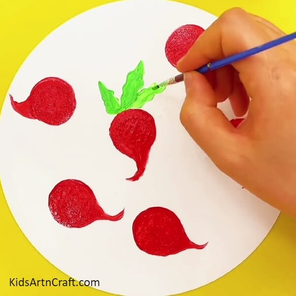 Painting Multiple Leaves in the Red Turnips- A colourful peacock painting idea for kids to make using their fingers.