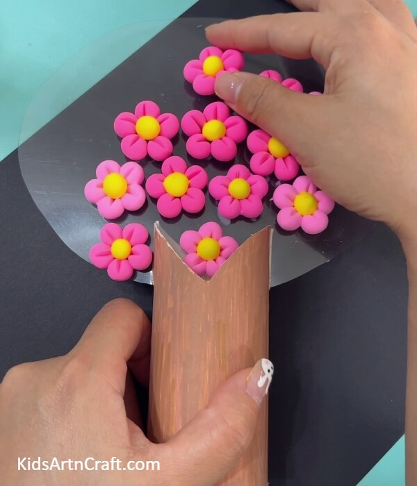 Sticking more flowers to make cherry blossom tree- Fabricating a Super-Clay Cherry Blossom Tree Out of a Toilet Paper Roll 