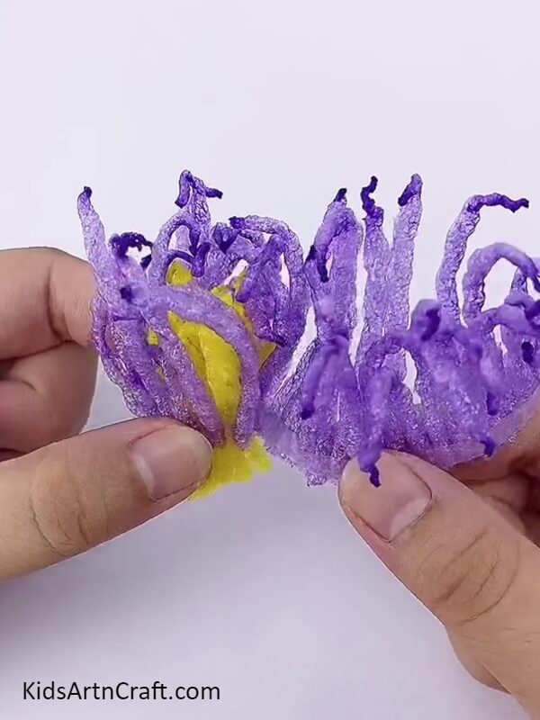 Wrapping The Purple Foam Around The Yellow Foam To Make A Flower-