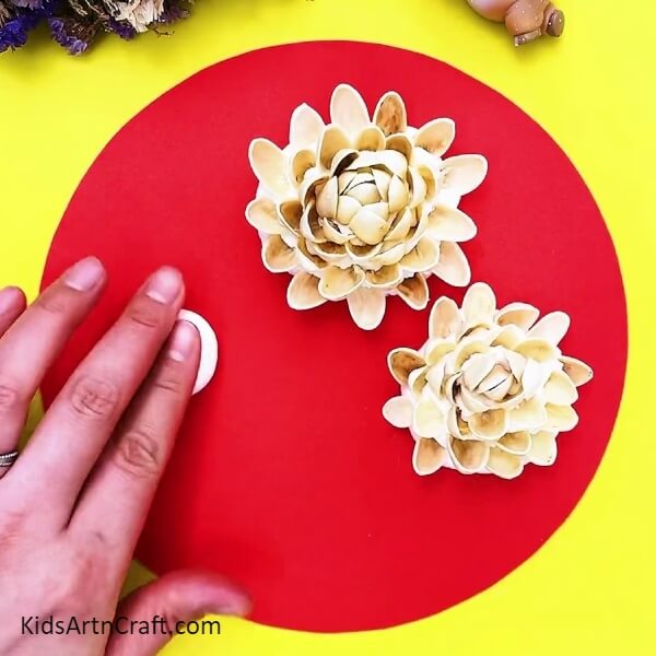 Stick Another Piece Of Clay To Make More Flowers-Pretty Peanut Shell Rose Garden Craft project for youngsters.