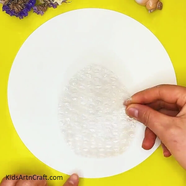 Begin with cutting in a Oval shape- Craft Project Guide For Little Ones Utilizing Bubble Wrap And A Honeycomb Design