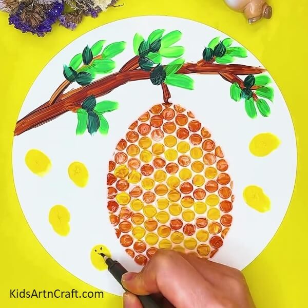 Draw Eyes and mouth on the yellow prints- Bubble Wrap And Honey Bee Comb Art Help For Kids