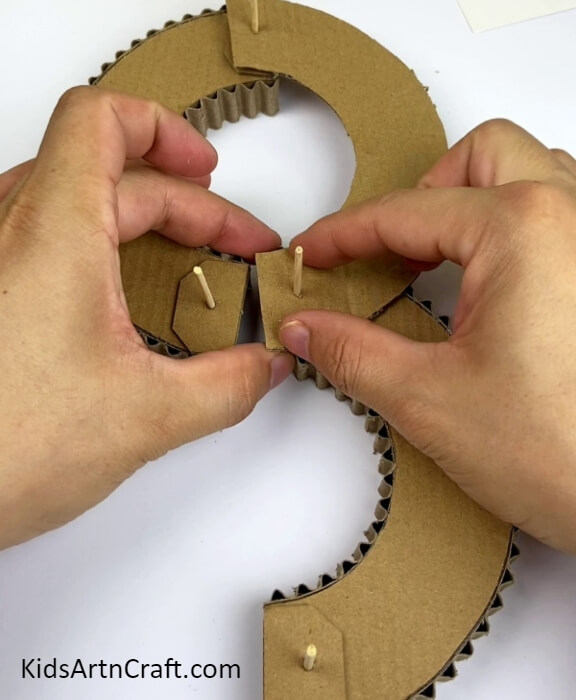 Inserting The Other Ring Piece- Creating a unique cardboard track for a cars and ball game craft idea.