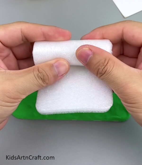 Rolling A Piece Of Foam Sheet-