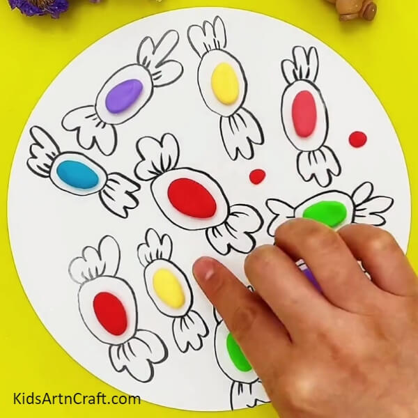 Make Small Circles With Red Clay- An art project for beginners - building colorful clay candies! 