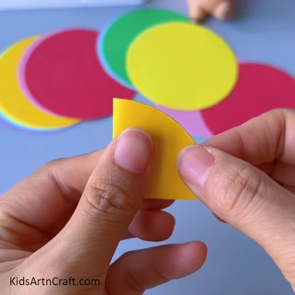 Pasting the creased side-complete procedure on how to make Colorful Paper Quarters craft for beginner