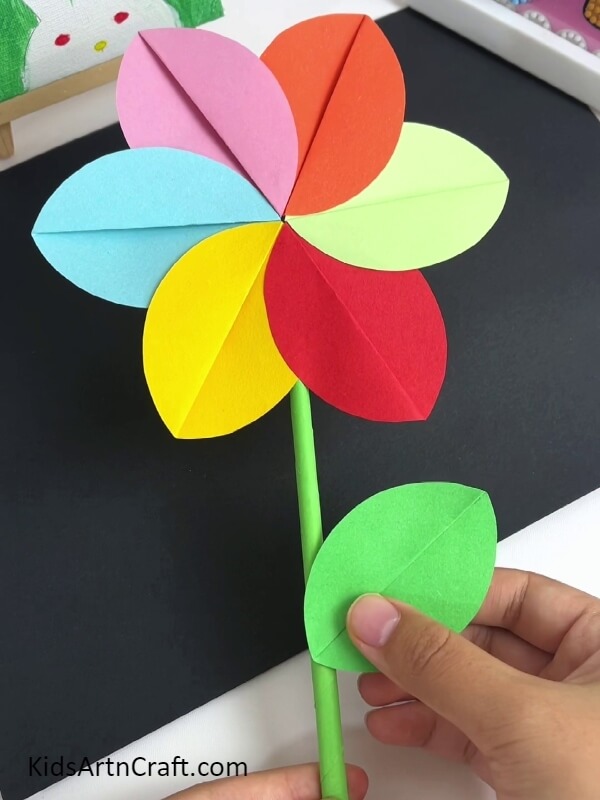 Adding The Leaf-Designing a colorful pinwheel-shaped flower craft for beginners 