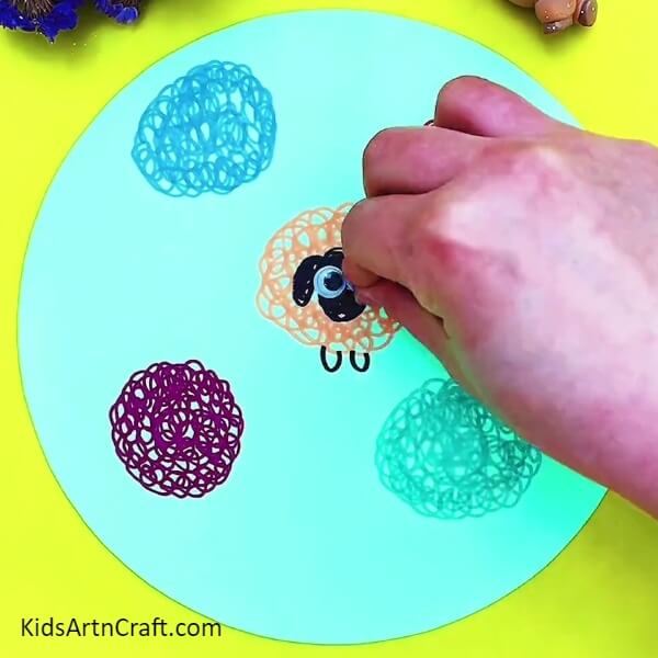 Stick googly eyes with glue- A Tutorial for the Artistically Challenged: Creating a Colorful Sheep Garden Drawing 