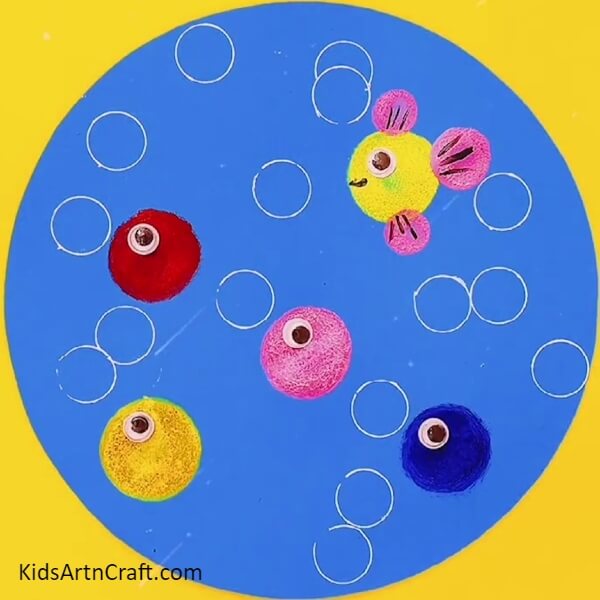 Pasting Googly Eyes On All Fish- Letting young minds explore their artistic side with colorful stamping fish underwater art. 