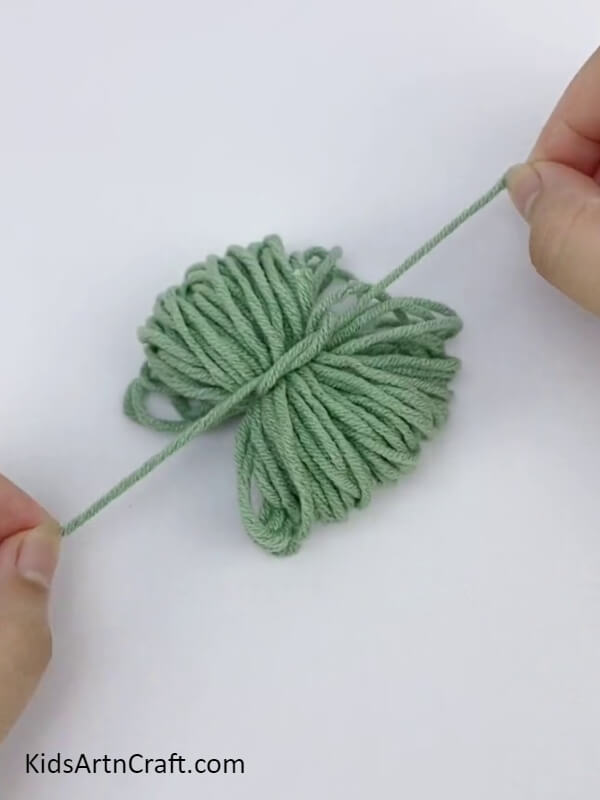 Tying The Bundle Together- Tutorial for helping children to create Pom Pom Flowers with colorful threads. 