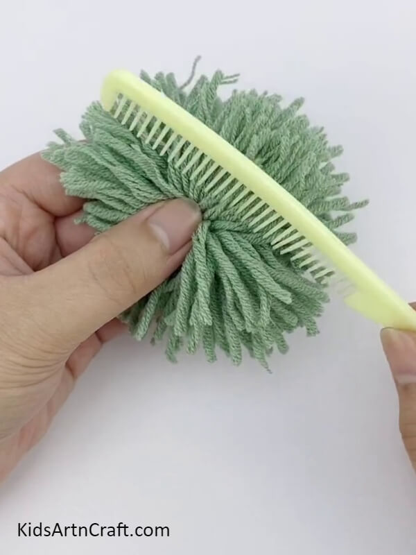 Combing Through The Cut Threads- Tutorial to assist children in making Pom Pom Flowers with an array of colors. 