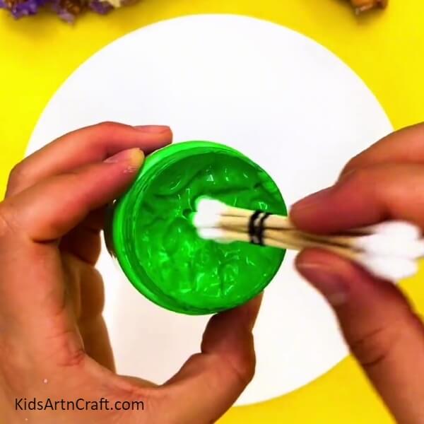 Dipping The Earbuds Into Green Paint- Step-by-step Guideline to Produce a Colorful Tree Cotton Bud Painting 