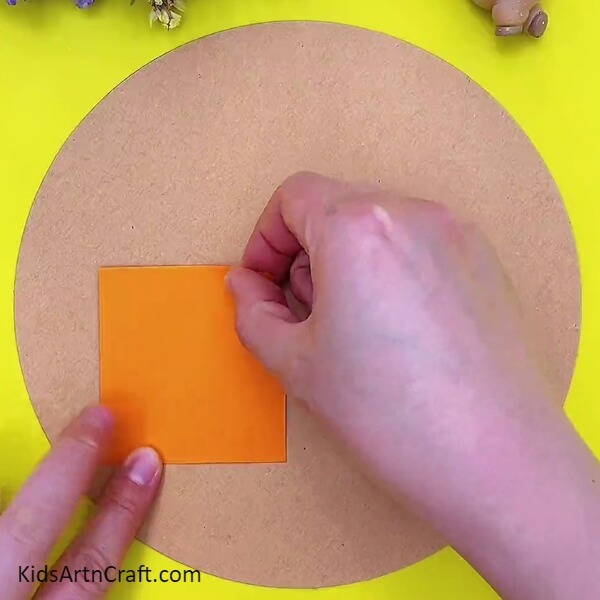 Pasting an orange house. Step-by-step guide of Craft Paper House And Tree Scenery Easy Tutorial for Kids