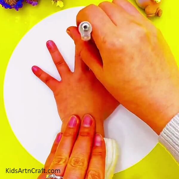 Outlining The Hand Using A Pencil- Kids can use their hands to draw a creative cactus