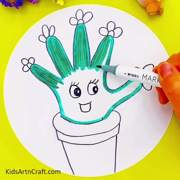 Coloring The Cactus- An imaginative cactus drawing that can be done with a hand outline as an idea for kids