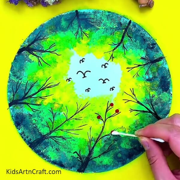 Making Red Dot on sheet using Red colours. Step-by-Step Procedure of Forest Painting Art Tutorial For childrens.