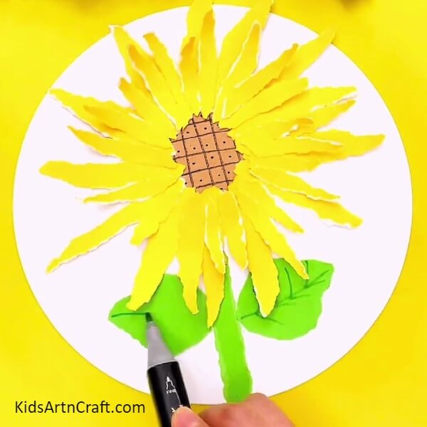 Adding Leaves To The Flower- A creative paper sunflower craft concept for novices 