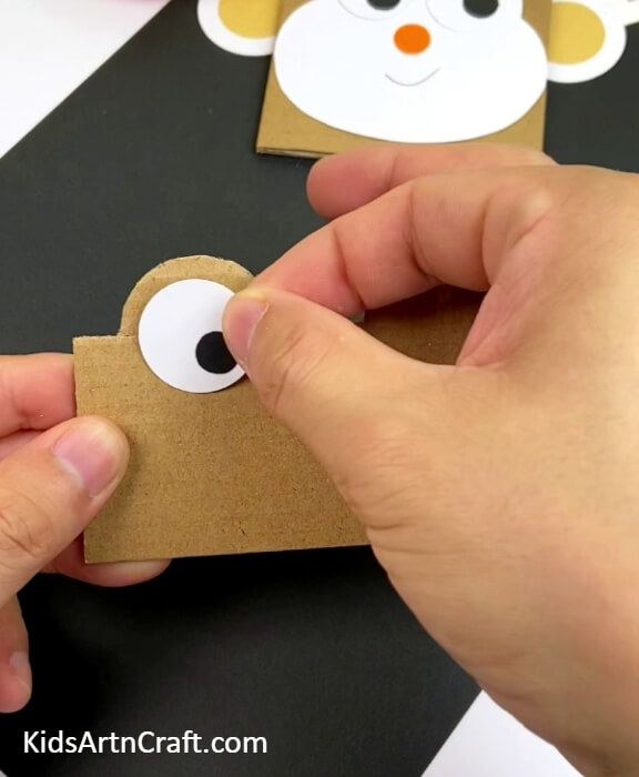 Pasting Left Eye On The Frog Face-Simple Tutorial for Making Animal Masks with Cardboard